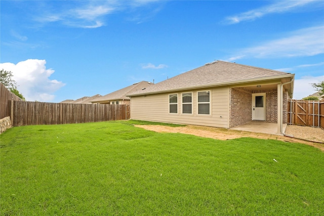 906 Silverbell St, Princeton, TX 75407 - rear view of property with a fenced backyard, brick siding, a patio, and roof with shingles