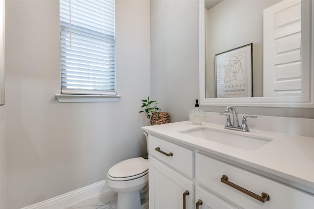 8977 George Cayley Ln, Frisco, TX 75034 - half bath with marble look tile flooring, vanity, toilet, and baseboards