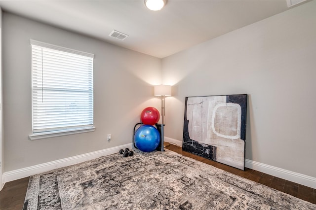 8977 George Cayley Ln, Frisco, TX 75034 - workout room featuring baseboards and wood finished floors