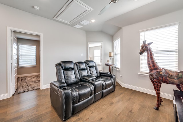 8977 George Cayley Ln, Frisco, TX 75034 - home theater featuring wood finished floors, baseboards, vaulted ceiling, and recessed lighting