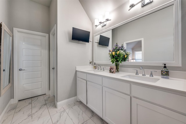 8977 George Cayley Ln, Frisco, TX 75034 - bathroom featuring double vanity, marble finish floors, and baseboards