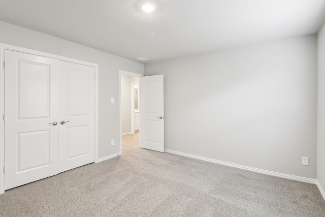 901 Lily Ln, Lavon, TX 75166 - unfurnished bedroom with light colored carpet, baseboards, and a closet