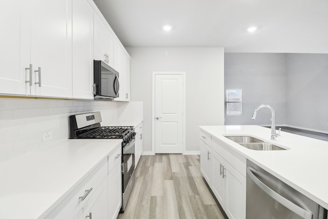 901 Lily Ln, Lavon, TX 75166 - kitchen featuring appliances with stainless steel finishes, a sink, backsplash, light countertops, and recessed lighting