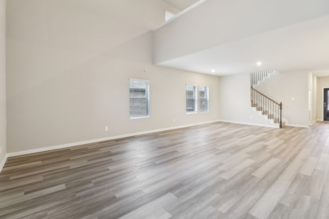 901 Lily Ln, Lavon, TX 75166 - unfurnished living room featuring stairs, light wood-type flooring, baseboards, and recessed lighting
