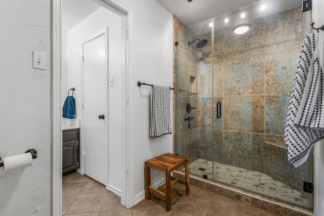 3213 Kingsbridge Dr, Plano, TX 75075 - bathroom with tile patterned flooring, a stall shower, vanity, and baseboards