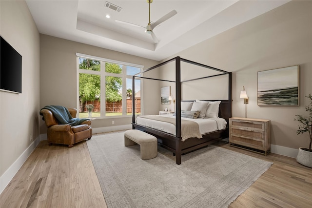 3313 Jackson Ct, Grapevine, TX 76092 - bedroom with wood finished floors, a tray ceiling, baseboards, and a ceiling fan