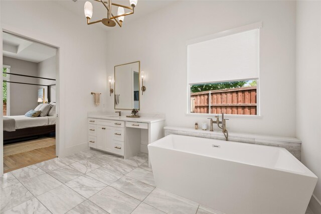 3313 Jackson Ct, Grapevine, TX 76092 - full bath with healthy amount of natural light, vanity, a freestanding tub, and marble finish floors