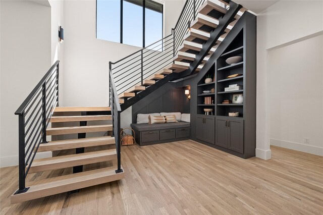 3313 Jackson Ct, Grapevine, TX 76092 - staircase featuring wood finished floors, baseboards, a towering ceiling, and built in features
