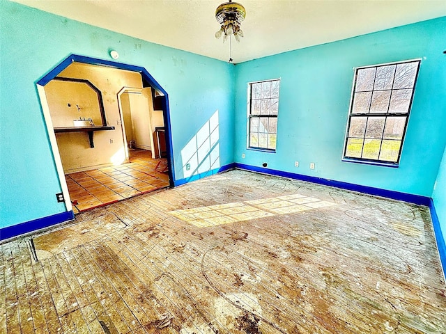2641 Old Anson Rd, Abilene, TX 79603 - empty room featuring arched walkways, baseboards, and a ceiling fan