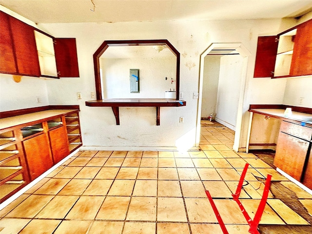2641 Old Anson Rd, Abilene, TX 79603 - kitchen featuring arched walkways and light tile patterned flooring