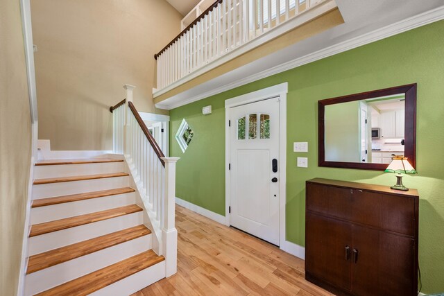 1432 Cimarron Trl, Hurst, TX 76053 - foyer entrance with wood finished floors, stairway, baseboards, and a high ceiling