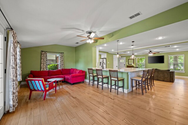 1432 Cimarron Trl, Hurst, TX 76053 - living area featuring ceiling fan, light wood-style flooring, baseboards, and lofted ceiling
