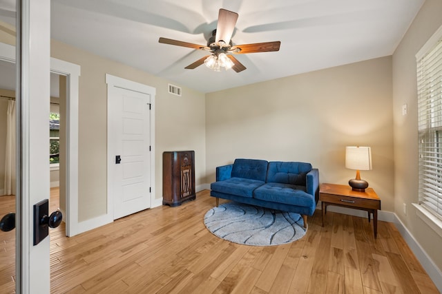 1432 Cimarron Trl, Hurst, TX 76053 - living area featuring a ceiling fan, light wood-style flooring, and baseboards