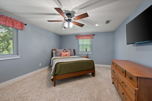1432 Cimarron Trl, Hurst, TX 76053 - bedroom featuring baseboards, light carpet, and a ceiling fan
