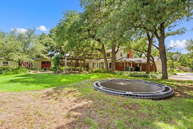 1432 Cimarron Trl, Hurst, TX 76053 - view of green lawn with a trampoline and a pergola