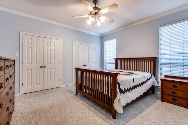 1521 Etain Rd, Irving, TX 75060 - carpeted bedroom with two closets, crown molding, a ceiling fan, and baseboards