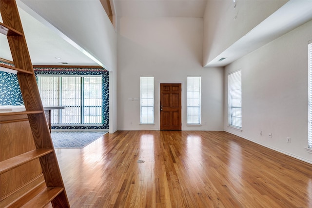 1521 Etain Rd, Irving, TX 75060 - entrance foyer with a towering ceiling, wood finished floors, and baseboards