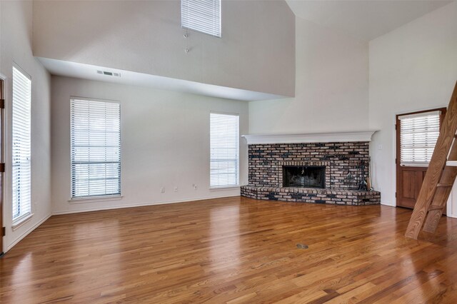 1521 Etain Rd, Irving, TX 75060 - unfurnished living room with a high ceiling, wood finished floors, and healthy amount of natural light
