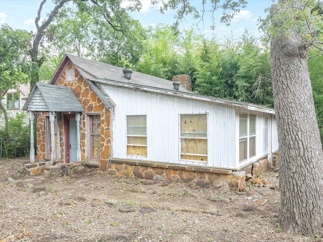 203 E 9th St, Shady Shores, TX 76208 - view of front of house with stone siding and a chimney