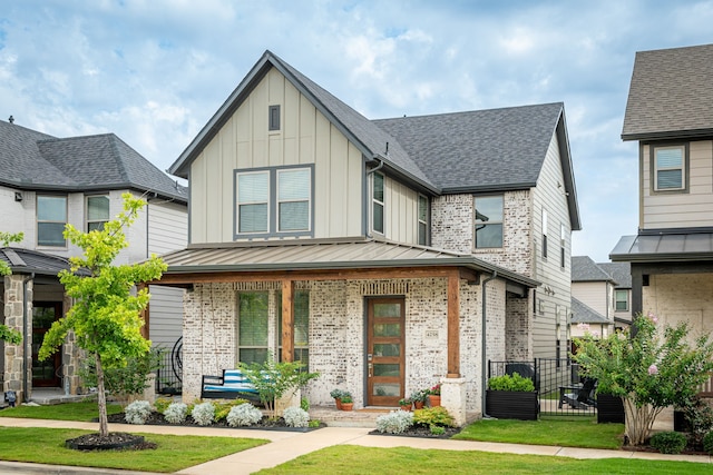 4258 Sechrist Dr, Frisco, TX 75034 - view of front facade featuring a porch, board and batten siding, brick siding, and roof with shingles