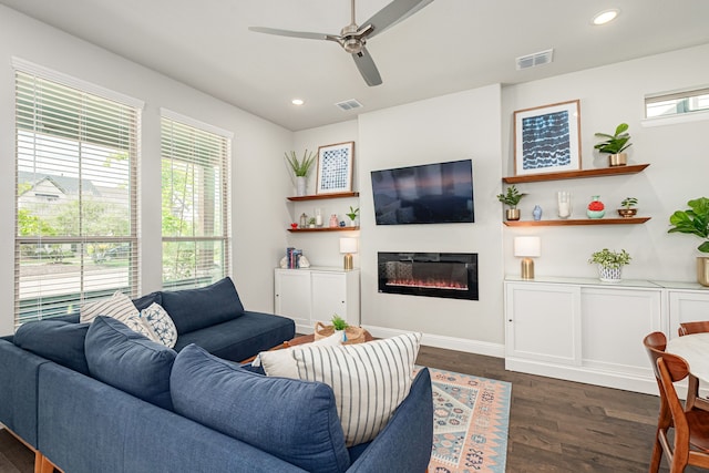 4258 Sechrist Dr, Frisco, TX 75034 - living room featuring plenty of natural light, a glass covered fireplace, dark wood finished floors, ceiling fan, and recessed lighting