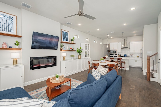 4258 Sechrist Dr, Frisco, TX 75034 - living area featuring ceiling fan, a glass covered fireplace, recessed lighting, and dark wood-style floors