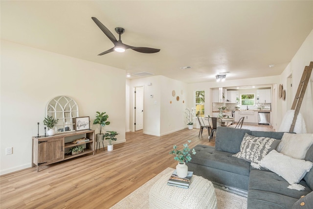 1534 Burger St, Abilene, TX 79603 - living room featuring light wood-style flooring, baseboards, and a ceiling fan