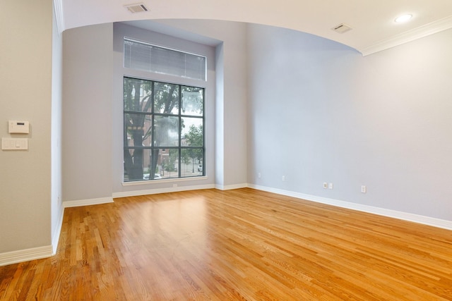 2205 Canton St Unit 107, Dallas, TX 75201 - spare room featuring light wood finished floors, baseboards, and crown molding