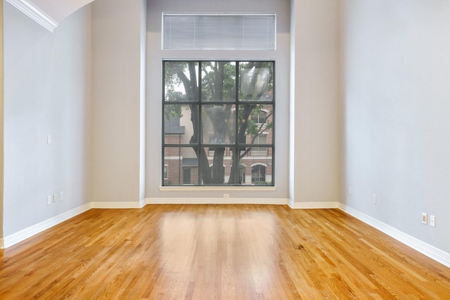 2205 Canton St Unit 107, Dallas, TX 75201 - spare room with baseboards, wood finished floors, and ornamental molding