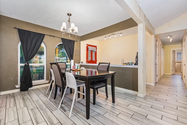 801 Daventry Dr, Garland, TX 75040 - dining area with a chandelier, wood tiled floors, and rail lighting
