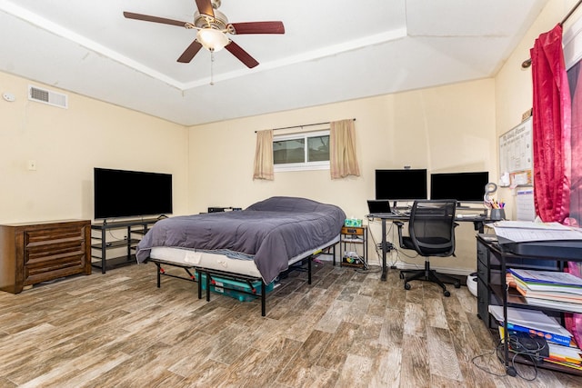 801 Daventry Dr, Garland, TX 75040 - bedroom with wood finished floors, a raised ceiling, a desk, and a ceiling fan