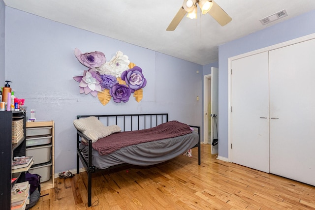 801 Daventry Dr, Garland, TX 75040 - bedroom with wood finished floors, ceiling fan, and a closet