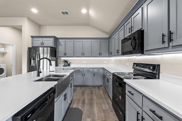 3216 Maroon Creek Rd, Aubrey, TX 76227 - kitchen featuring black appliances, lofted ceiling, washer / clothes dryer, light countertops, and a sink