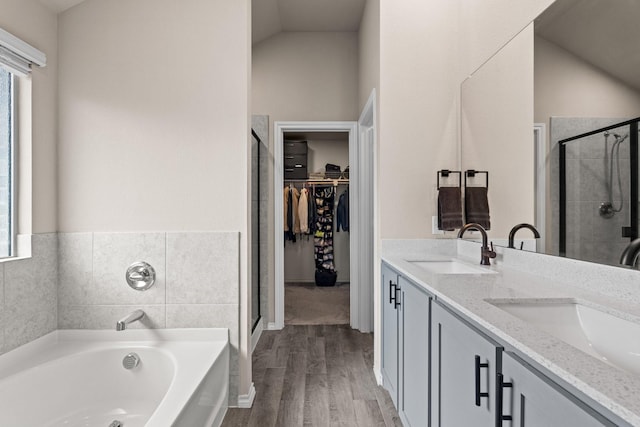 3216 Maroon Creek Rd, Aubrey, TX 76227 - full bathroom featuring a stall shower, wood finished floors, healthy amount of natural light, and vaulted ceiling