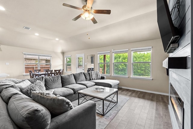 3216 Maroon Creek Rd, Aubrey, TX 76227 - living area with wood finished floors, a glass covered fireplace, baseboards, a ceiling fan, and recessed lighting