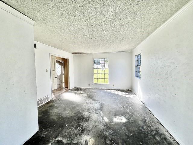 3201 Shoreview Dr, Cleburne, TX 76033 - spare room with a textured ceiling and concrete floors