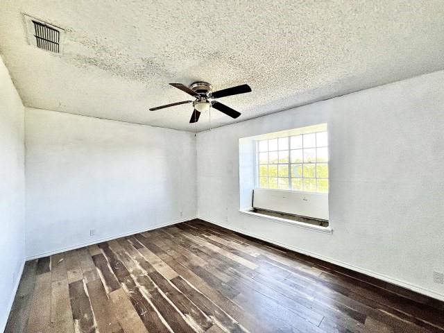 3201 Shoreview Dr, Cleburne, TX 76033 - spare room featuring dark wood-style floors, ceiling fan, and a textured ceiling