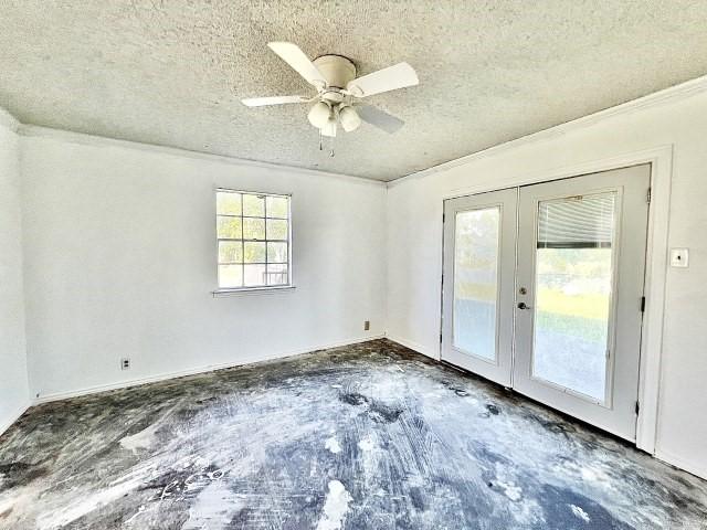 3201 Shoreview Dr, Cleburne, TX 76033 - empty room with french doors, a textured ceiling, a ceiling fan, and ornamental molding