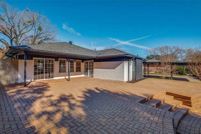 2028 Casa Loma Ct, Grapevine, TX 76051 - back of house with brick siding, roof with shingles, and a patio