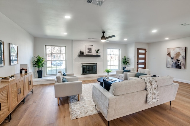 2028 Casa Loma Ct, Grapevine, TX 76051 - living area with healthy amount of natural light, a fireplace, ceiling fan, recessed lighting, and light wood-style floors