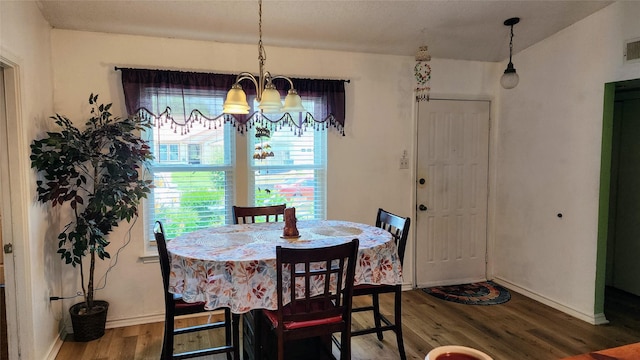 1718 Gentle Wind Dr, Arlington, TX 76018 - dining space with wood finished floors, healthy amount of natural light, and a chandelier