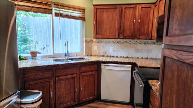 1718 Gentle Wind Dr, Arlington, TX 76018 - kitchen with appliances with stainless steel finishes, light stone counters, wood finished floors, and backsplash