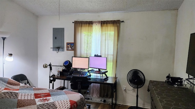 1718 Gentle Wind Dr, Arlington, TX 76018 - bedroom with a textured ceiling, electric panel, wood finished floors, and a desk