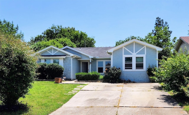 1718 Gentle Wind Dr, Arlington, TX 76018 - view of front of home with stucco siding, a front lawn, and stone siding