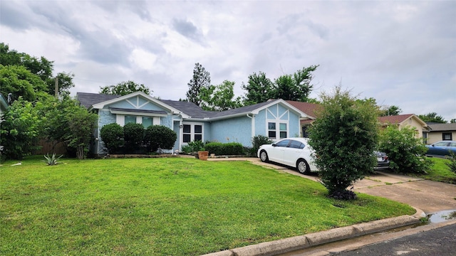 1718 Gentle Wind Dr, Arlington, TX 76018 - view of front of property with a front yard, stucco siding, and concrete driveway