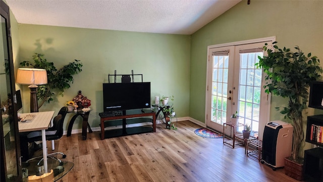 1718 Gentle Wind Dr, Arlington, TX 76018 - office featuring french doors, wood finished floors, healthy amount of natural light, vaulted ceiling, and a textured ceiling