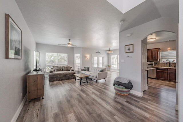 6204 Geneva Ln, Fort Worth, TX 76131 - living area with arched walkways, ceiling fan, plenty of natural light, and wood finished floors