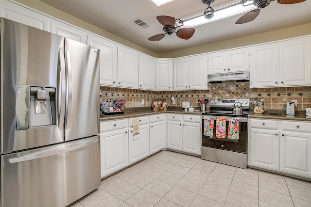134 Northchase Dr, Willow Park, TX 76087 - kitchen with stainless steel appliances, ceiling fan, under cabinet range hood, dark countertops, and light tile patterned floors