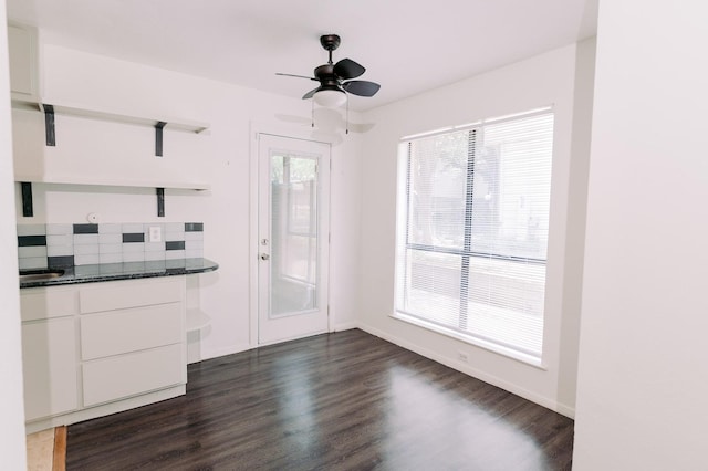 6646 E Lovers Ln Unit 301, Dallas, TX 75214 - unfurnished living room featuring dark wood-type flooring, ceiling fan, and baseboards
