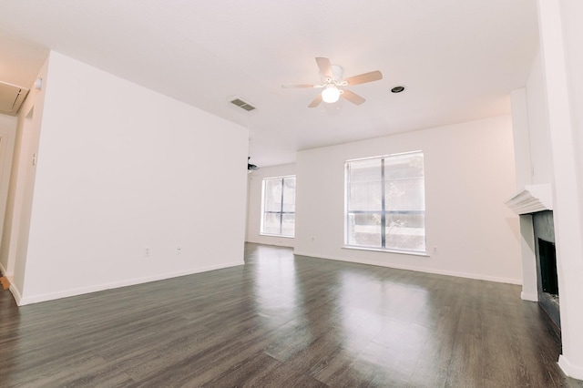 6646 E Lovers Ln Unit 301, Dallas, TX 75214 - unfurnished living room featuring a ceiling fan, dark wood-style floors, a fireplace, and attic access